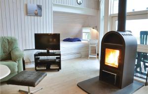 a living room with a fireplace and a television at Holiday Home Asperup 55 in Asperup +9 photos