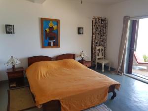 ein Schlafzimmer mit einem Bett und einem Wandgemälde in der Unterkunft Villa océane in Tôlagnaro