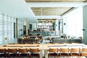 a lobby with couches and a table and chairs at Hotel It Osaka Shinmachi in Osaka