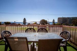 a table and chairs on a patio with a fence at Blue Seas Motel in Port Lincoln +13 photos