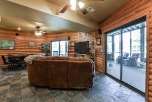 a living room with a large couch and a television at Luxury Lakefront Chalet Resort 2 Pools FREE Amenities Dock MiniGolf Waterslide in Lampe
