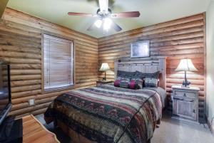 a bedroom with a bed and a ceiling fan at Luxury Lakefront Chalet Resort 2 Pools FREE Amenities Dock MiniGolf Waterslide in Lampe