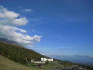 a building on the side of a hill at Kyukamura Iwate-Amiharionsen in Shizukuishi