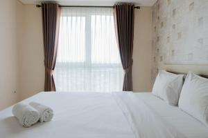 Postel nebo postele na pokoji v ubytování Comfy 1BR Apartment Casa De Parco Central BSD City By Travelio + 7 fotografií
