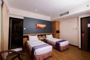 Postelja oz. postelje v sobi nastanitve Mariner Hotel Labuan