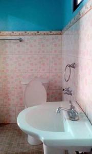 a bathroom with a toilet and a sink at Glenmark's Homestay 2 in Mabubua