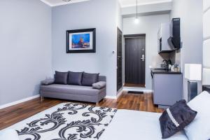 a living room with a bed and a couch at Tribeca City Center Apartments in Krakow
