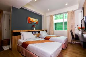 Postelja oz. postelje v sobi nastanitve Mariner Hotel Labuan