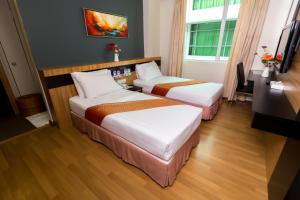 Postelja oz. postelje v sobi nastanitve Mariner Hotel Labuan