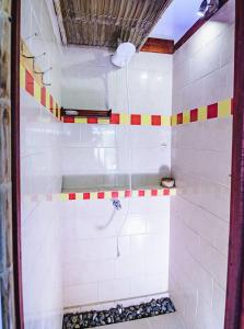 a bathroom with a shower withkeredkered tiles on the wall at Villa 6 - Luxury 2 Bed Villa - Small Private Garden in Cocles +10 photos