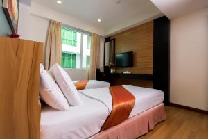 Postel nebo postele na pokoji v ubytování Mariner Hotel Labuan + 26 fotografií