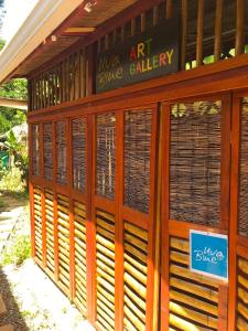 a building with wood shutters on the side of it at Villa 3 - High End Studio Apartment with kitchen, Playa Chiquita in Cocles