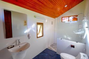 a white bathroom with a sink and a toilet at Rommai Villa Chiang Rai in Ban Pa Sang (1)