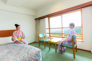 two women sitting in a hotel room looking out the window at Kyukamura Iwate-Amiharionsen in Shizukuishi
