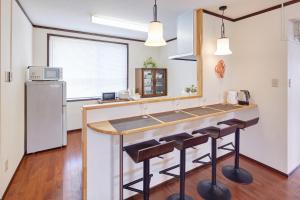 a kitchen with a counter and a refrigerator at Wind Makiminato in Urazoe