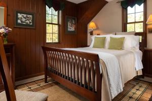a bedroom with a large bed and windows at Paddler's Lane Retreat in Confluence
