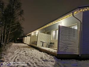 a house with lights on it in the snow at Arctic Resort Delight in Rovaniemi