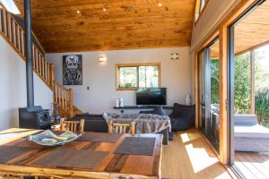 a living room with a wooden ceiling at Earth Energies Sanctuary in Mangatarata