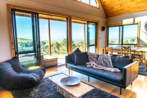 a living room with a couch and a table at Earth Energies Sanctuary in Mangatarata