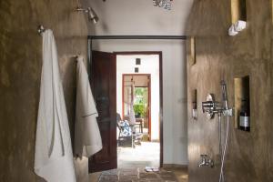 a bathroom with a shower and a door to a room at Why House in Unawatuna +38 photos