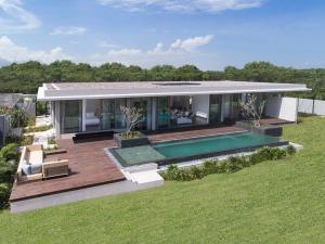 a house with a swimming pool in the backyard at Anantara Desaru Coast Resort & Villas in Desaru