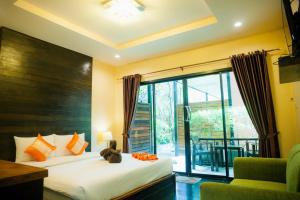 a bedroom with a bed and a large window at Leelawadee Lipe Resort in Ko Lipe