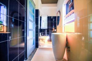 a bathroom with a toilet and a sink in it at Plernsalaya resort in Salaya +21 photos