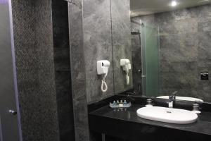 a bathroom with a sink and a mirror at Erebuni Hotel Yerevan in Yerevan