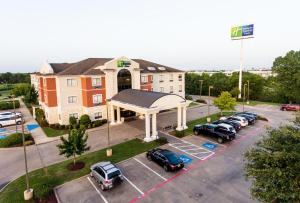 an aerial view of a hotel with cars parked in a parking lot at Holiday Inn Express Hotel & Suites Greenville, an IHG Hotel in Greenville