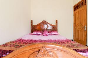 Ένα ή περισσότερα κρεβάτια σε δωμάτιο στο Dewisri Homestay