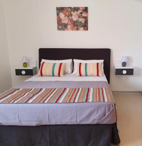 a bedroom with a large bed with two pillows at Camino De Rabe in Rabé de las Calzadas