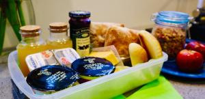 a plastic container filled with food and condiments at Fantail Bush Chalet in Parakakau