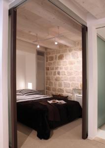 a room with a bed and a mirror in it at Miró Studio Apartments Dubrovnik in Dubrovnik