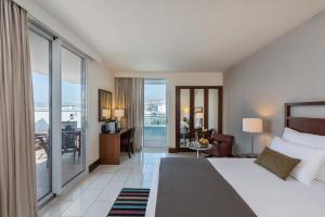 a hotel room with a bed and a balcony at King Solomon by Isrotel Collection in Eilat