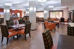 a dining room with tables and chairs in a restaurant at Holiday Inn Express Kingman, an IHG Hotel in Kingman
