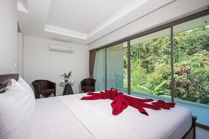 a bedroom with a bed with a red ribbon on it at 2 Bedroom Pool Villa in Quiet Location SDV005-By Samui Dream Villas in Mae Nam