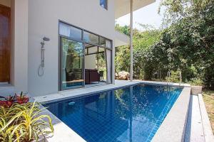 a swimming pool in front of a house at 2 Bedroom Pool Villa in Quiet Location SDV005-By Samui Dream Villas in Mae Nam