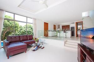 a living room with a couch and a kitchen at 2 Bedroom Pool Villa in Quiet Location SDV005-By Samui Dream Villas in Mae Nam