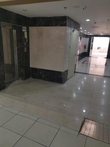 a empty room with a tile floor and a wall at Golden Dakhil in Al Madinah