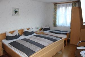 a bedroom with two beds and a window at Landgasthof Zur Tenne in Feuchtwangen +10 photos