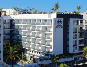 a large white building with palm trees in front of it at Gran Hotel Flamingo-Adults Only older 18 years old in Lloret de Mar