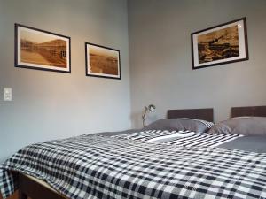 a bedroom with two beds and three pictures on the wall at Ferienwohnung Lahnbachallee, Schwaz in Schwaz