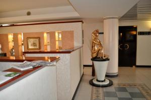 a hotel lobby with a statue of a woman at Best Western Hotel Solaf in Medolago