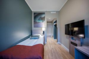 Postel nebo postele na pokoji v ubytování Quality Hotel Saga