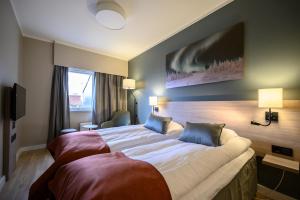 Postel nebo postele na pokoji v ubytování Quality Hotel Saga
