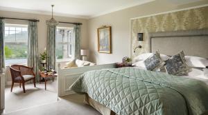 a bedroom with a bed and a chair and a window at Park Hotel Kenmare in Kenmare