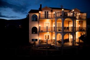 a large building with lights on it at night at Apartments Villa Paradise in Kaštela