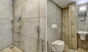 a bathroom with a shower and a toilet and a sink at Hotel Luciya in Cochin