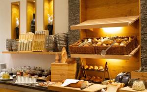 a bakery with lots of bread and baskets of bread at ... mein romantisches Hotel Toalstock in Fiss