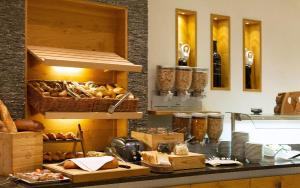 a kitchen with a counter with bread and other foods at ... mein romantisches Hotel Toalstock in Fiss